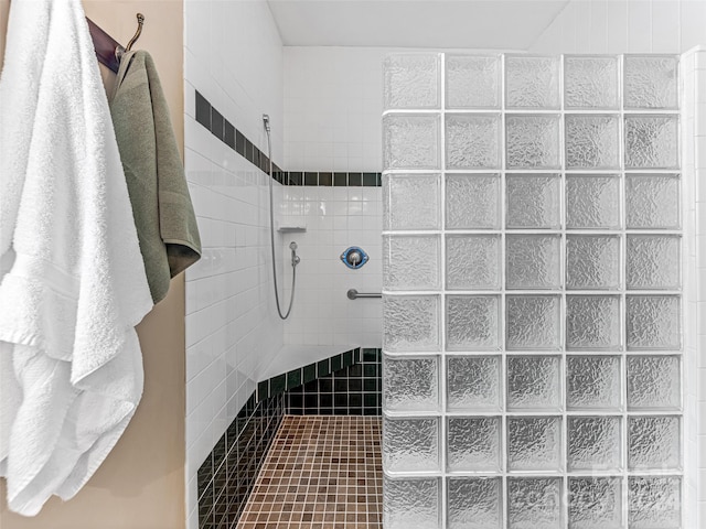 bathroom with tile patterned floors and tiled shower