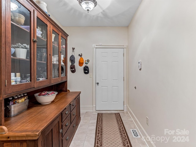 doorway featuring light tile patterned flooring