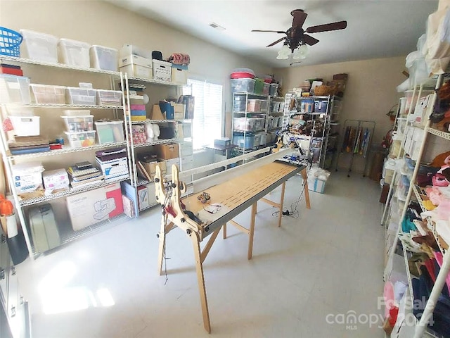 interior space with ceiling fan