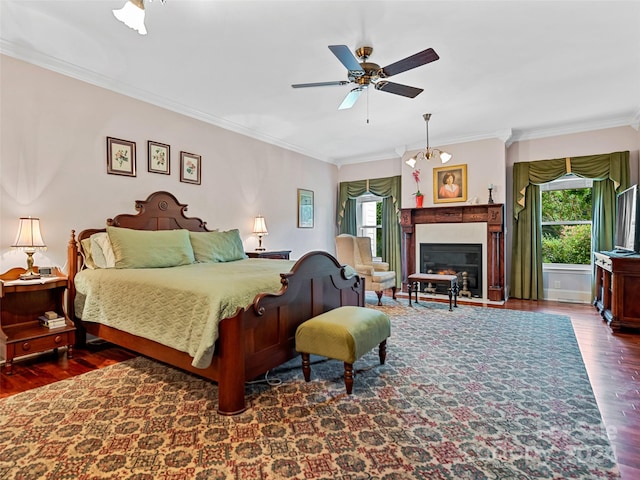 bedroom with ceiling fan with notable chandelier, dark hardwood / wood-style floors, and ornamental molding