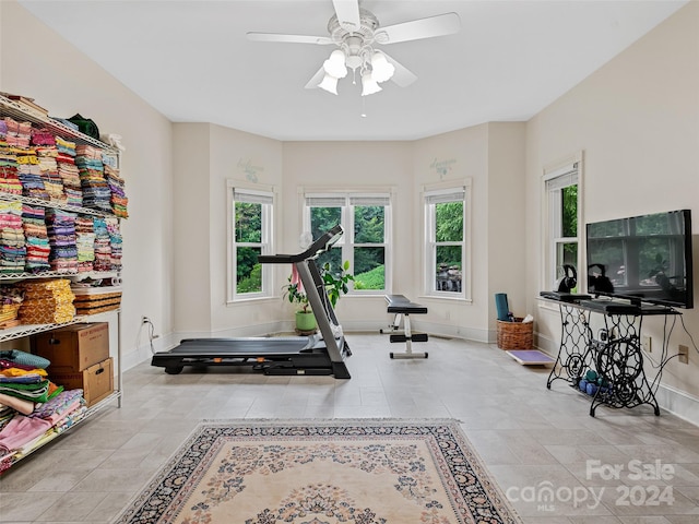 exercise room with ceiling fan