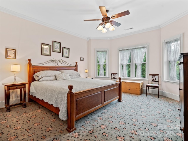 carpeted bedroom with ceiling fan, ornamental molding, and multiple windows