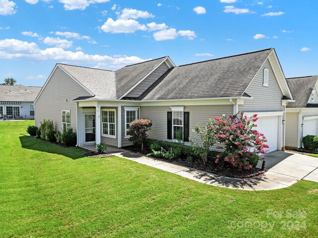 view of front of home featuring a garage and a front yard