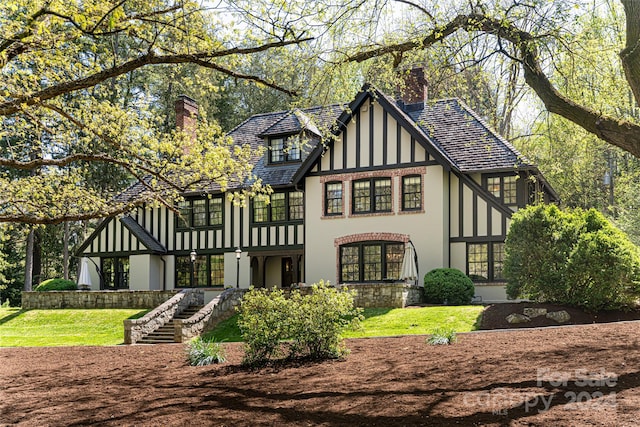 rear view of property with a lawn