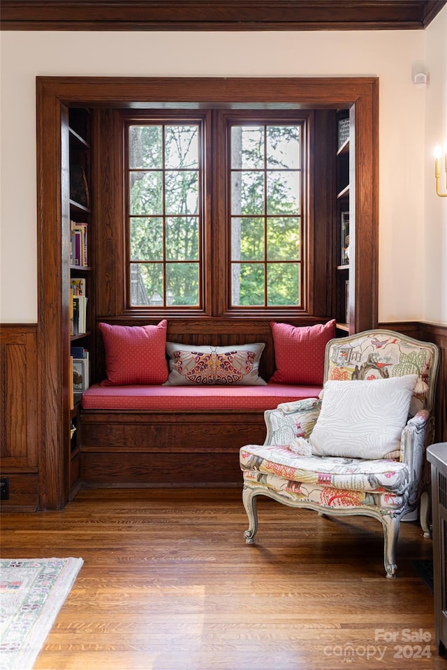 sitting room featuring wood walls and wood-type flooring