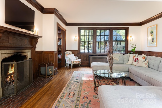 living room with dark hardwood / wood-style flooring and ornamental molding