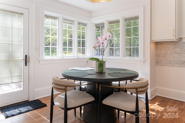 dining space with wood-type flooring