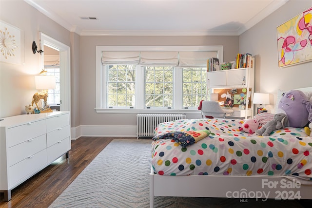 bedroom with radiator heating unit, dark hardwood / wood-style flooring, and ornamental molding