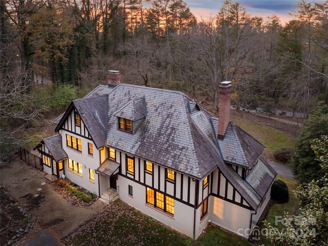 view of back house at dusk