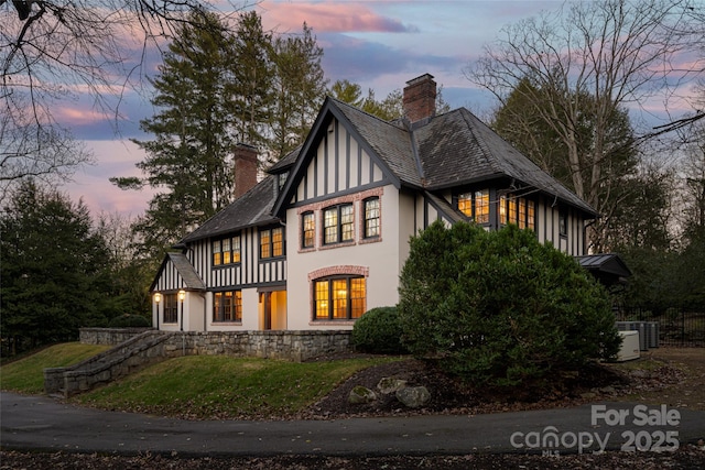 30 Cedarcliff Rd, Asheville, NC 28803 - rear view of house with a chimney, stucco siding, and a yard