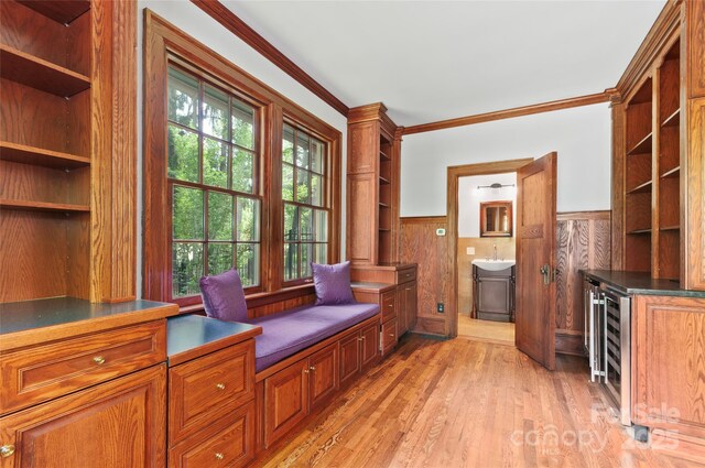 30 Cedarcliff Rd, Asheville, NC 28803 - sitting room featuring wainscoting, crown molding, light wood-type flooring, and wine cooler