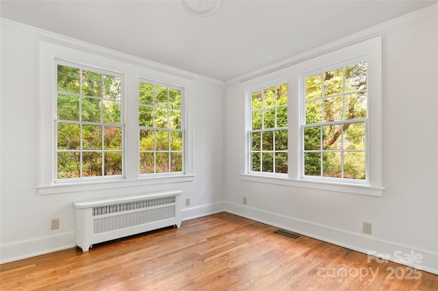 30 Cedarcliff Rd, Asheville, NC 28803 - unfurnished room with radiator heating unit, light wood-type flooring, baseboards, and ornamental molding