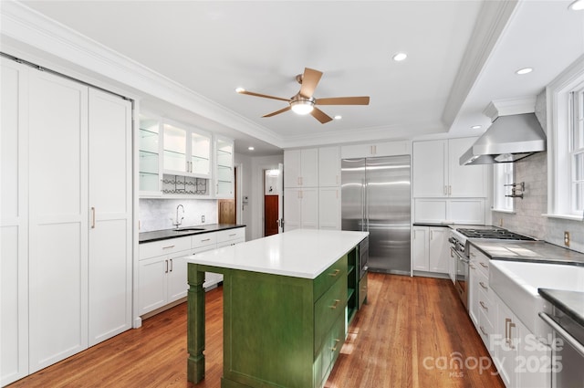 30 Cedarcliff Rd, Asheville, NC 28803 - kitchen featuring premium appliances, wall chimney range hood, a sink, a kitchen island, and recessed lighting
