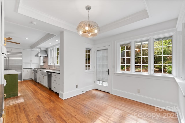 30 Cedarcliff Rd, Asheville, NC 28803 - unfurnished dining area with a chandelier, baseboards, light wood-type flooring, crown molding, and a tray ceiling