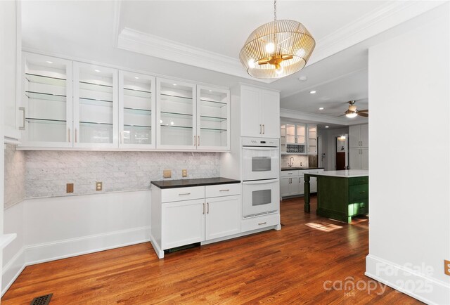 30 Cedarcliff Rd, Asheville, NC 28803 - kitchen with crown molding, tasteful backsplash, white cabinets, dark wood-type flooring, and glass insert cabinets