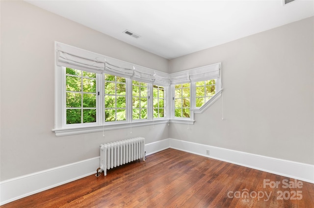 30 Cedarcliff Rd, Asheville, NC 28803 - empty room featuring radiator heating unit, dark wood-style flooring, and baseboards