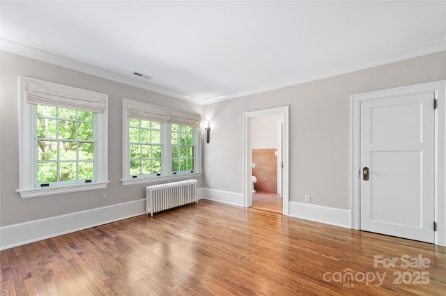 30 Cedarcliff Rd, Asheville, NC 28803 - spare room featuring radiator heating unit, wood finished floors, crown molding, and baseboards