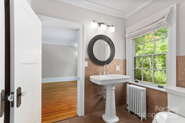 30 Cedarcliff Rd, Asheville, NC 28803 - half bathroom with radiator heating unit, ornamental molding, tile walls, tile patterned floors, and a sink