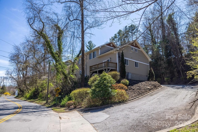 view of home's exterior featuring a wooden deck