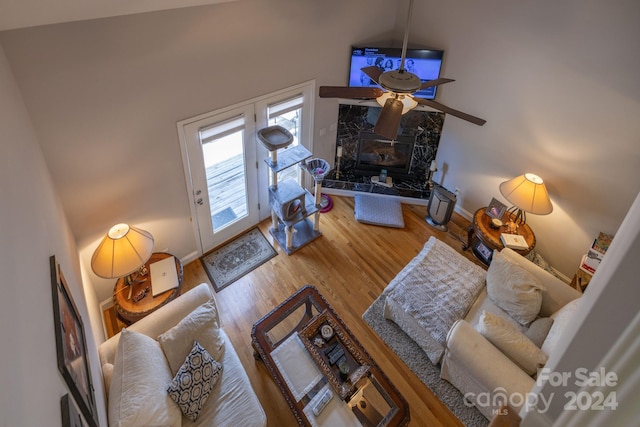 living room featuring hardwood / wood-style flooring, high vaulted ceiling, and ceiling fan