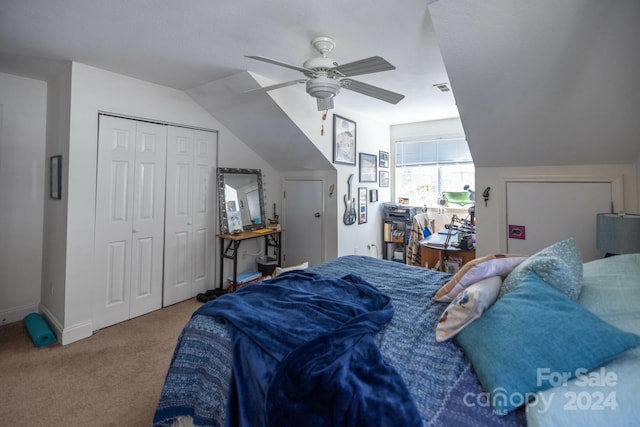 bedroom with a closet, ceiling fan, carpet floors, and lofted ceiling