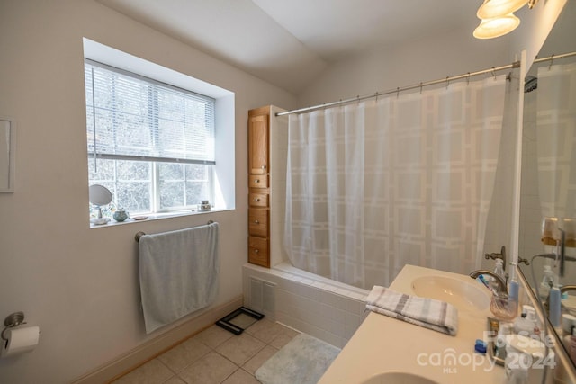 bathroom with vaulted ceiling, shower / bath combo, vanity, and tile flooring