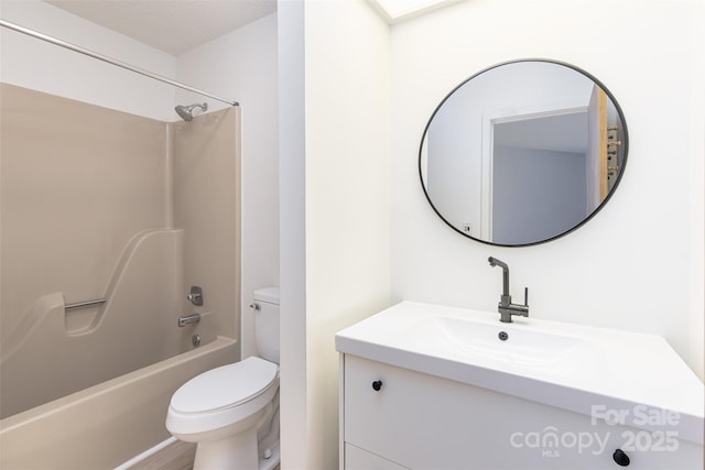 full bathroom with vanity, a textured ceiling, tub / shower combination, and toilet