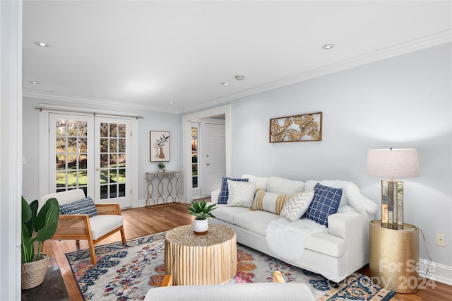 living room featuring french doors, ornamental molding, and hardwood / wood-style flooring