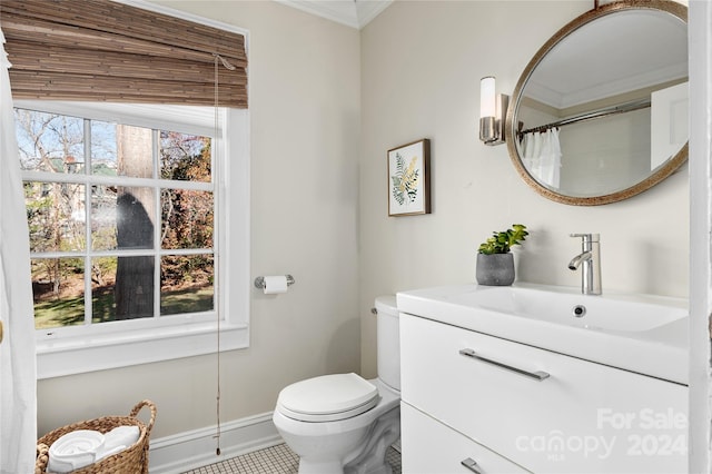 bathroom with tile patterned flooring, plenty of natural light, vanity, and ornamental molding