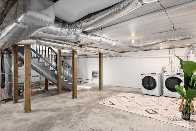 basement featuring separate washer and dryer and heating unit