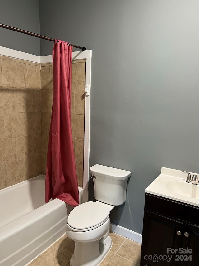 full bath with tile patterned floors, toilet, shower / tub combo, baseboards, and vanity