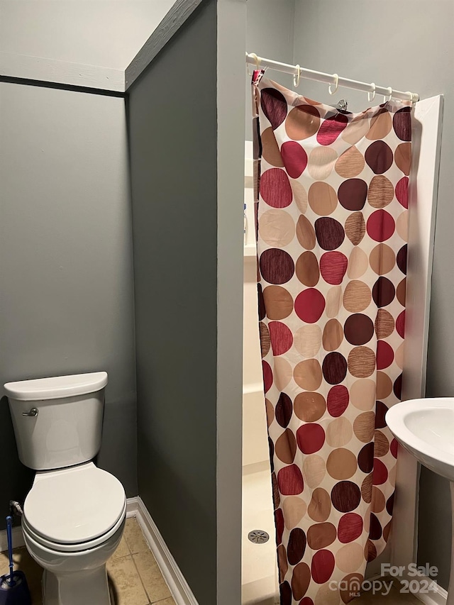 full bath featuring tile patterned floors, baseboards, a shower with curtain, and toilet