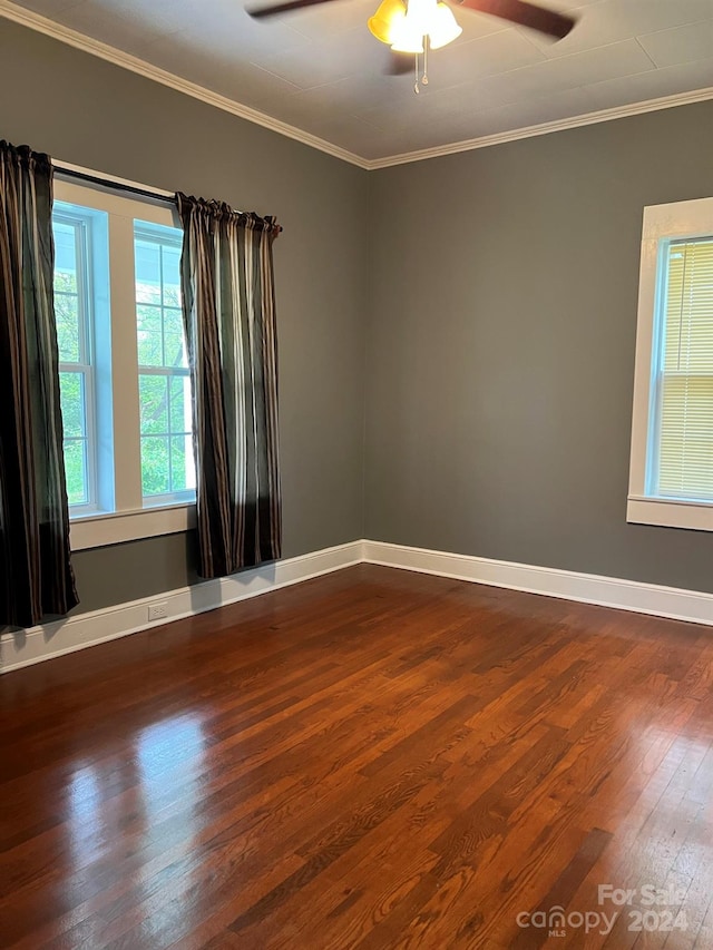 unfurnished room featuring baseboards, dark wood-style floors, a ceiling fan, and ornamental molding