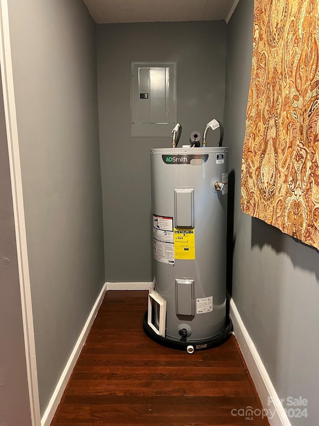 utility room with electric panel and electric water heater