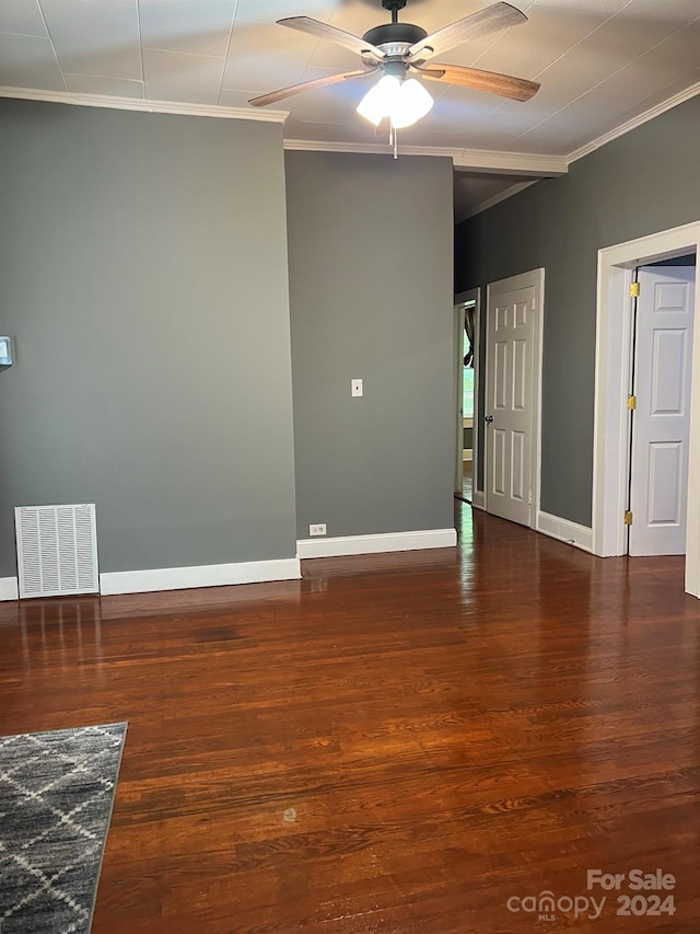 unfurnished room with wood finished floors, baseboards, visible vents, ceiling fan, and ornamental molding