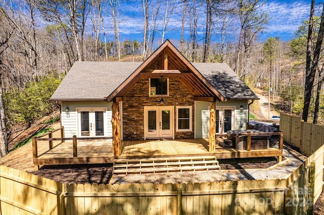 view of front of house with a deck and french doors