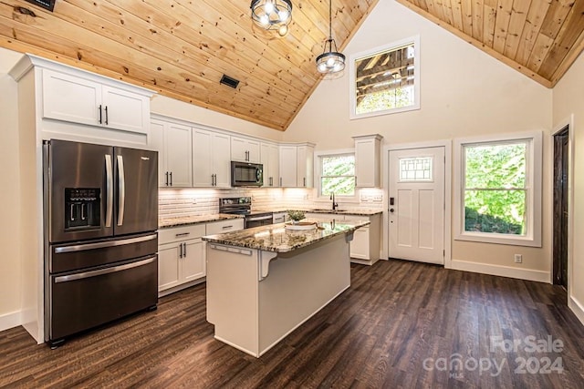 kitchen featuring electric range oven, hanging light fixtures, stainless steel fridge, wooden ceiling, and stone counters