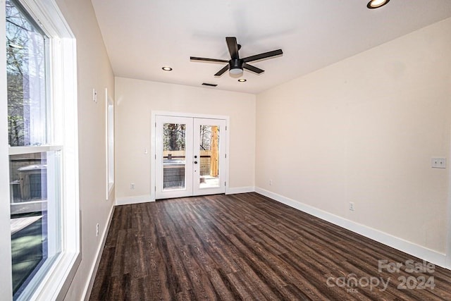 spare room with ceiling fan, french doors, and dark hardwood / wood-style flooring