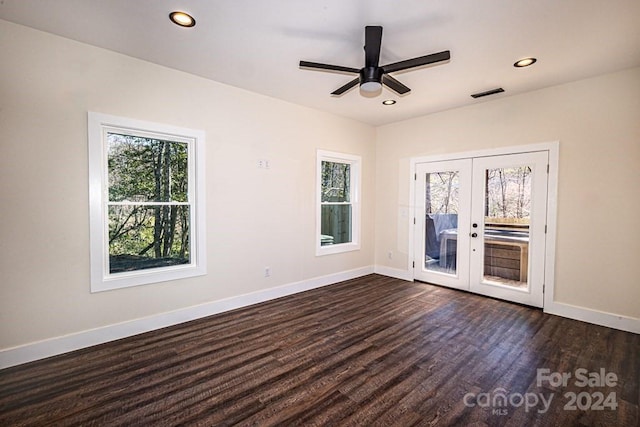 empty room featuring dark hardwood / wood-style floors, french doors, and ceiling fan