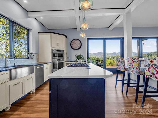 kitchen featuring stainless steel appliances, pendant lighting, a mountain view, and a kitchen island