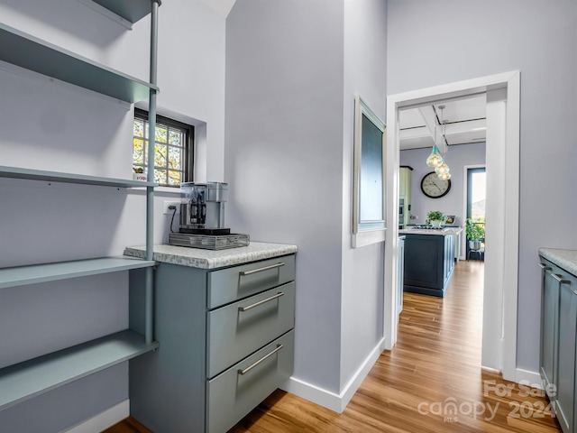 kitchen with light wood-type flooring and gray cabinetry