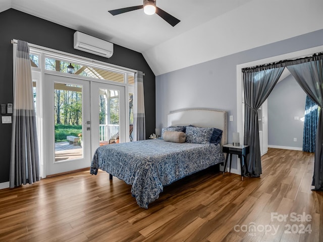 bedroom featuring hardwood / wood-style floors, lofted ceiling, a wall unit AC, access to outside, and ceiling fan