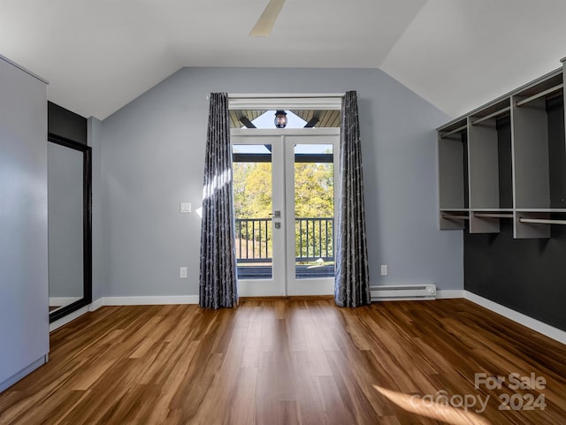 interior space featuring hardwood / wood-style flooring, ceiling fan, baseboard heating, lofted ceiling, and french doors