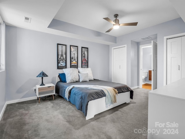 bedroom featuring ceiling fan, ensuite bathroom, and carpet floors