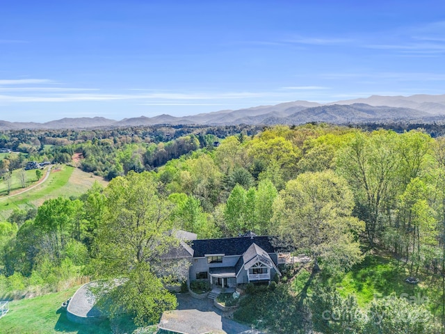 birds eye view of property with a mountain view and a wooded view