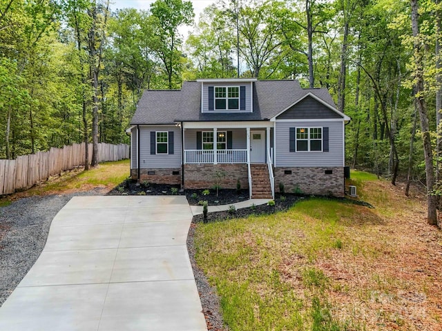 view of front of property with covered porch and a front yard