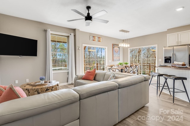 living room featuring ceiling fan and light hardwood / wood-style floors