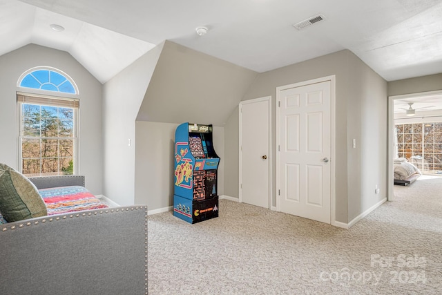 recreation room featuring light colored carpet, ceiling fan, and lofted ceiling