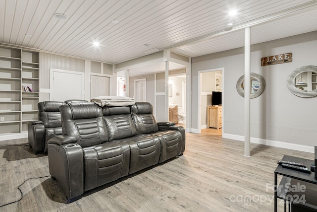 cinema room featuring light hardwood / wood-style flooring and wood ceiling