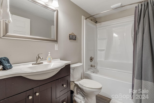 full bathroom with vanity, shower / bathtub combination with curtain, and toilet